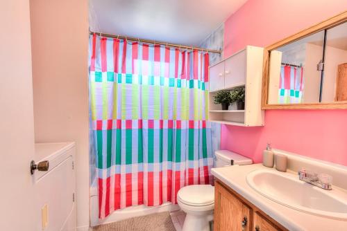 a bathroom with a colorful shower curtain and a toilet at Spacious 2BR ! 6 guest Vacation home Montreal in Montréal
