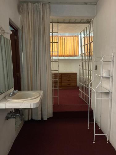 a bathroom with a sink and a bunk bed at Hotel Los Proceres in La Aurora