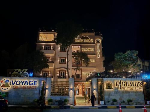 a large white building with a tree in front of it at Pyramids Spiritual Gate in Cairo