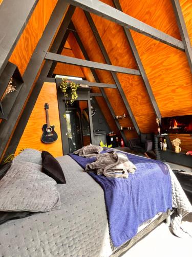 une chambre avec un lit et une guitare dans une pièce dans l'établissement Constelacaodachapada, à Ibicoara