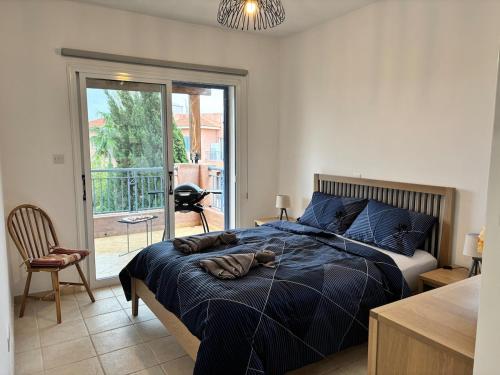 a bedroom with a bed and a sliding glass door at Large apartment in an idyllic complex, ocean view in Mandria