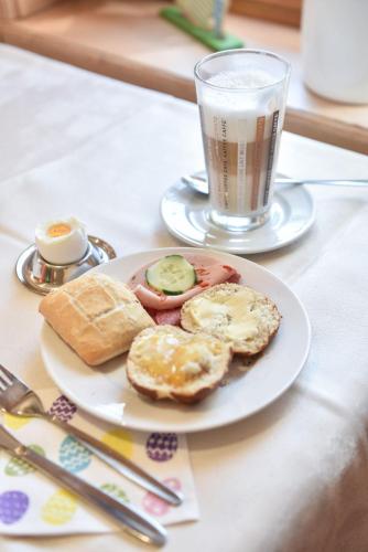 a plate with eggs and bread and a glass of milk at Hotel Gasthof Süßer Grund in Albstadt