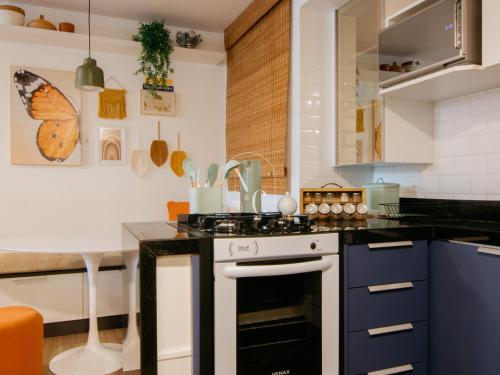 a kitchen with a black and white stove top oven at RioDowntown Hub by RNC Flats in Rio de Janeiro