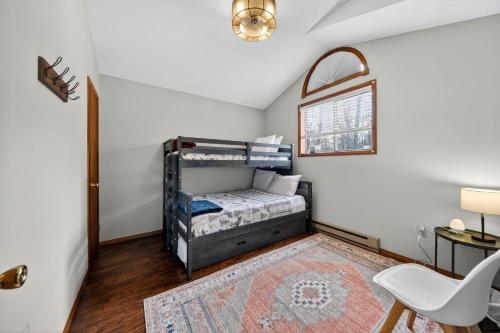 a bedroom with a bunk bed and a rug at Private Pocono Retreat with Hot Tub and Fire Pit in Thornhurst