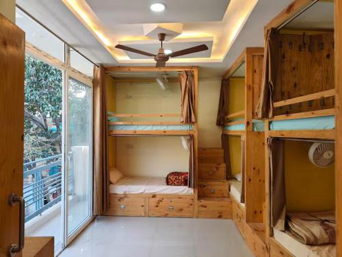 a room with bunk beds in a tiny house at Solo Nari Backpackers Rishikesh in Narendranagar