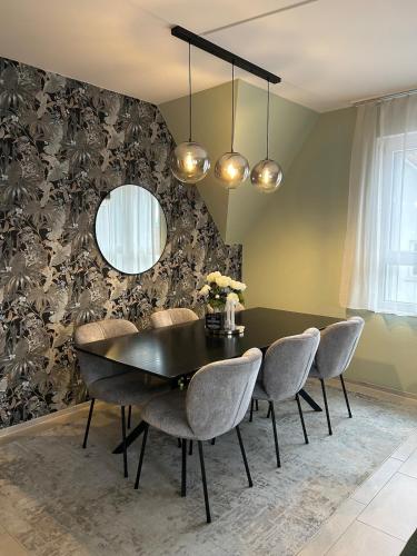 a dining room with a black table and chairs at Maisonette am Bodensee - Parking - Hoher Komfort in Rorschach