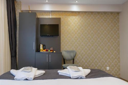 a bedroom with a bed and a chair and a television at Grand Sezgin Hotel in Istanbul