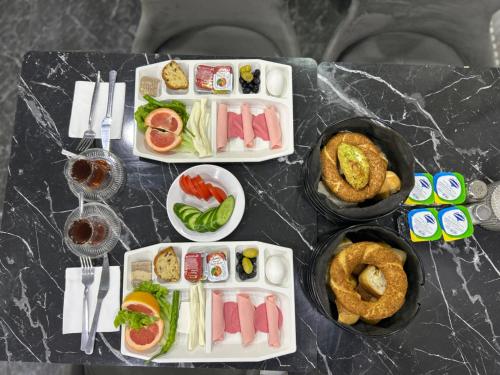 a table with plates of food on a table at Grand Sezgin Hotel in Istanbul