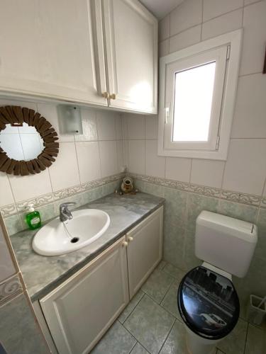 a bathroom with a sink and a toilet at Casa Tesoreta in Cala en Forcat