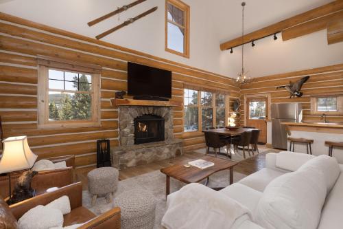 a living room with wooden walls and a fireplace at Powder Ridge Cabin - 9A Red Cloud in Big Sky