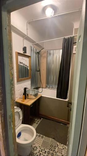 a bathroom with a toilet and a sink and a tub at UltracentrART in Craiova