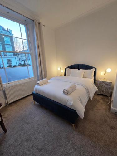 a large bed in a room with a large window at Camden Mia Apa in London
