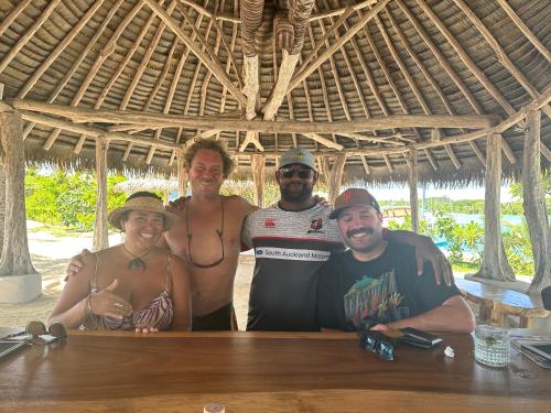 a group of people posing for a picture at a table at Sujees surf stay, cloudbreak in Nadi