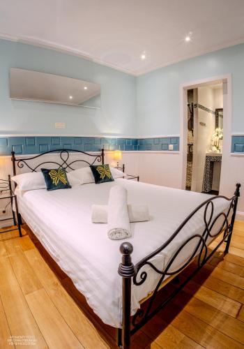a bedroom with a large bed with white sheets at Hostel Lybeer Private Rooms just for two! in Bruges