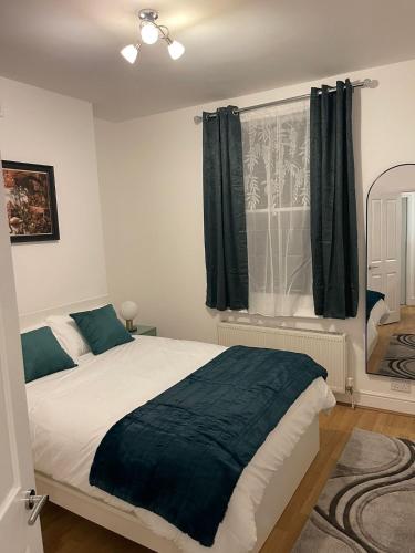 a bedroom with a large bed and a window at Acon Heights in London