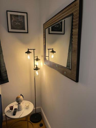 a room with two lights and a table with a mirror at Acon Heights in London