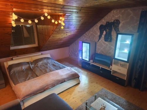 a bedroom with a large bed in a attic at Apartmán GRAND Lučenec in Lučenec