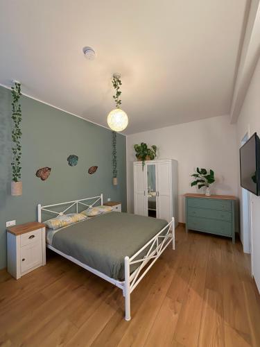 a bedroom with a bed and a television in it at B&B Sunny's House in Bologna