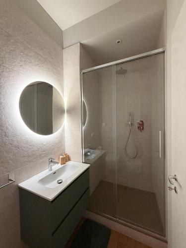 a bathroom with a sink and a glass shower at B&B Sunny's House in Bologna