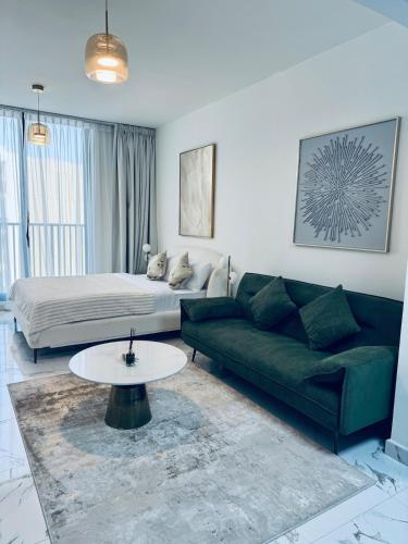 a living room with a couch and a coffee table at Huge Stunning Studio Private Beach Access in Ras al Khaimah