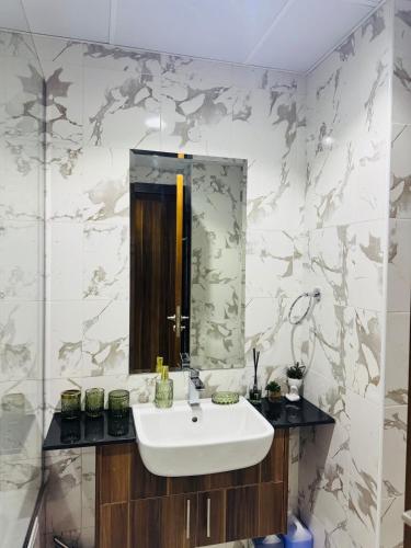 a bathroom with a sink and a mirror at Huge Stunning Studio Private Beach Access in Ras al Khaimah