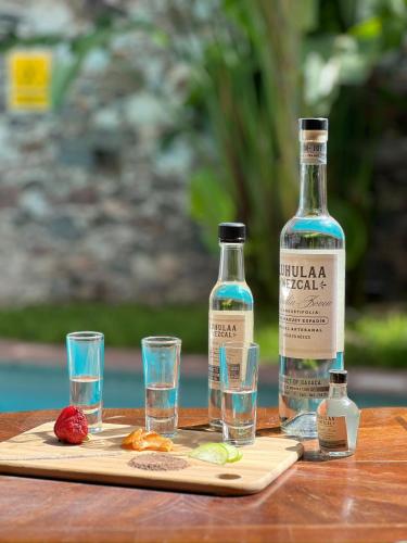 a bottle of vodka and glasses of water on a table at Hotel Casa Loreto San Miguel de Allende in San Miguel de Allende
