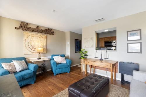 a living room with a couch and a table at Downtown Nashville Riverfront Condo in Nashville
