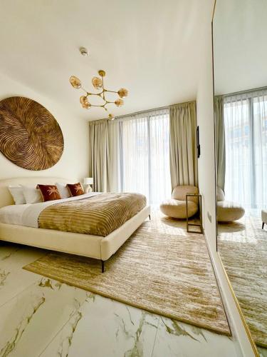 a bedroom with a large bed and a large window at Luxurious 1BR Apartment with Private Beach in Ras al Khaimah