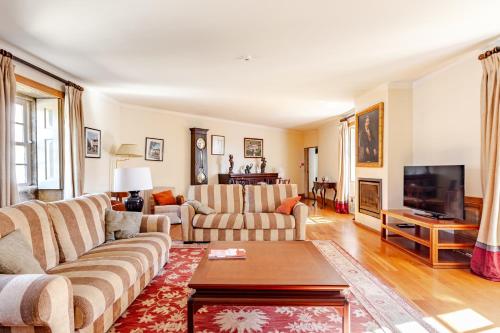 a living room with two couches and a tv at Casa dos Avós in Perre