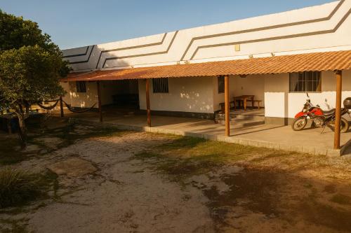 a building with two motorcycles parked outside of it at Residencial céu aberto in Porto Seguro