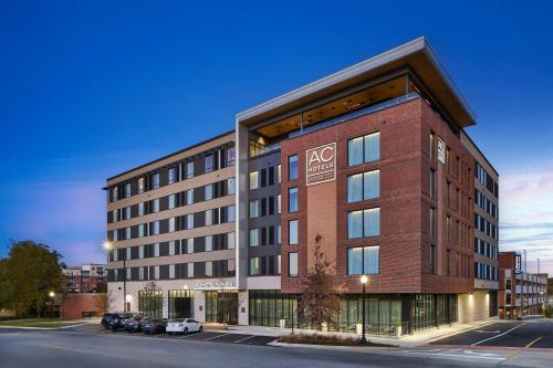 a large brick building on a city street at AC Hotel by Marriott Auburn in Auburn