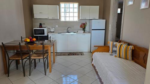 a kitchen with a table and a dining room at Vasilikis Place in Elafonisos