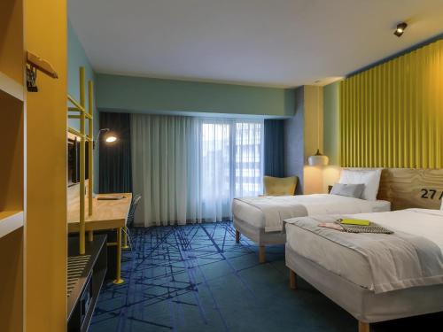 Ένα ή περισσότερα κρεβάτια σε δωμάτιο στο ibis Styles Bucharest Erbas