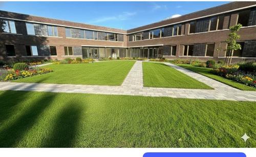 a large building with a green lawn in front of it at Lely in Lelystad