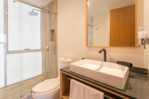 a bathroom with a sink and a toilet and a shower at Amazing Condo Ocean View By Bamboo Skylife in Acapulco