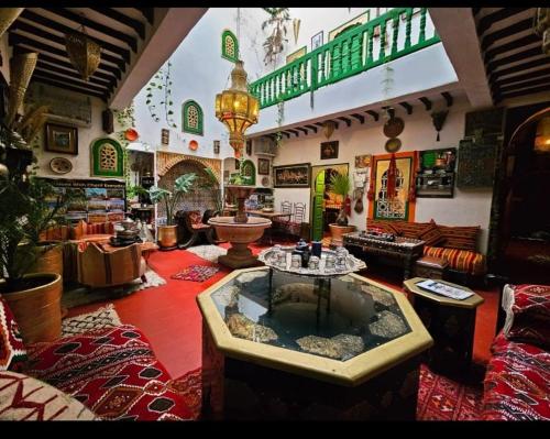 a large living room with a fish tank in the middle at riad cherif in Marrakech
