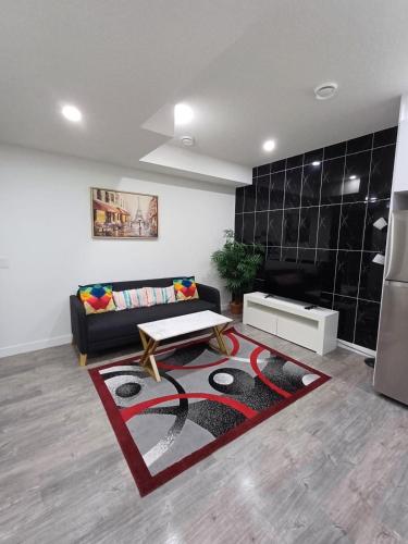 a living room with a couch and a table at Haven Lodge, 2BR Brand New Basement Suite in Calgary
