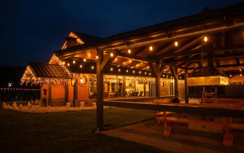 a building lit up at night with christmas lights at Meștera 9 in Stînceni