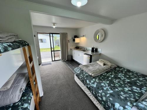 a bedroom with two bunk beds and a sink at Parklands Marina Holiday Park in Picton