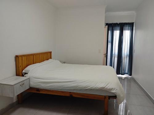 a bedroom with a bed and a window at Spring Cottage in Walvis Bay