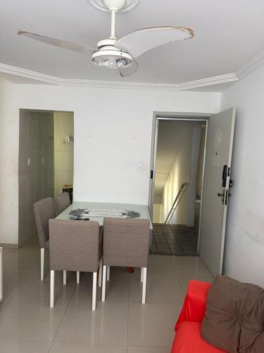 a dining room with a table and chairs and a couch at Gilvan Rocha in Aracaju