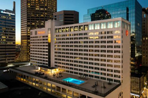 a tall white building with a pool in front of it at Sheraton Indianapolis City Centre Hotel in Indianapolis
