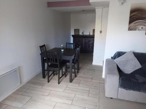 a living room with a table and a couch at Magnifique Studios proche de Paris dans le Yvelines in Ecquevilly