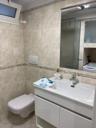 a bathroom with a sink and a toilet and a mirror at Dimora Marina in Giovinazzo