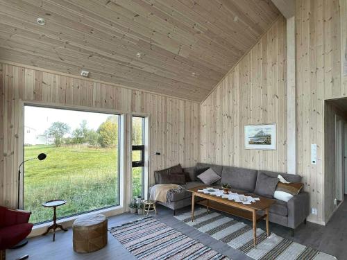 a living room with a couch and a table at Newly Built Cabin On Andøya With Northern Lights in Bø Andøya