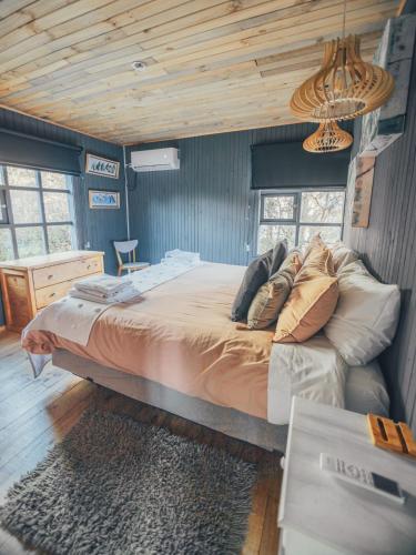 a bedroom with a large bed in a house at Casa Taller Meular Chiloé in Castro