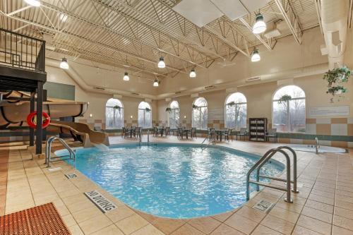 a large swimming pool in a building with a piano at Best Western Plus Pembina Inn & Suites in Winnipeg