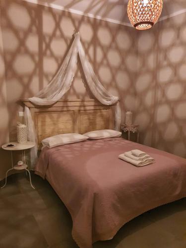 a bedroom with a large bed with a canopy at Dimora Storica Gold Room in Ruviano