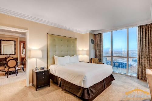 a bedroom with a large bed and a large window at MGM Signature-15-802 1Br 2Ba F1 Pits View Balcony in Las Vegas