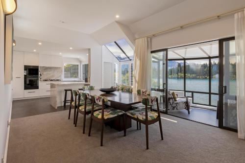 a kitchen and dining room with a table and chairs at Queenstown House Lakeside in Queenstown